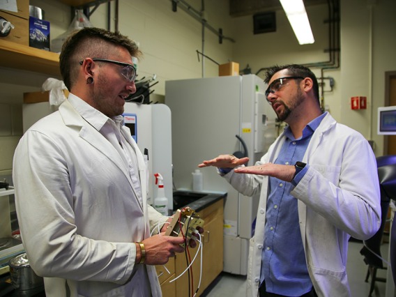 CarbeniumTech co-founders Thomas Gianetti and Joules Moutet talking in their lab.