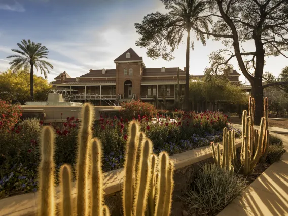 Photograph of a sunrise over the Old Main building. 