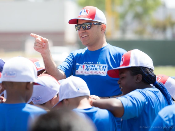 Ricardo Valerdi on the baseball field with students.