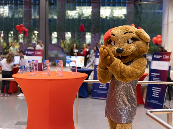 Wilma WIldcat poses with the 2022 I-Squared awards, ready to be handed out to the recipients.