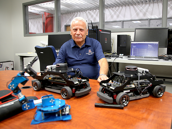 Salim Hariri with robotic technology in his laboratory. 