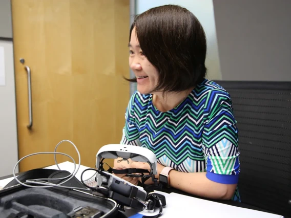 Inventor Hong hua smiling, working at the lab.