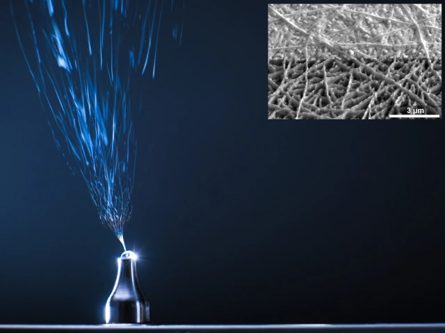An image of a needle electrospinning fibers into solution-processed electronic thin films.