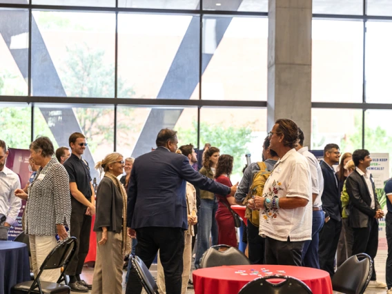 Attendees peruse expo tables at I-Squared 2025.