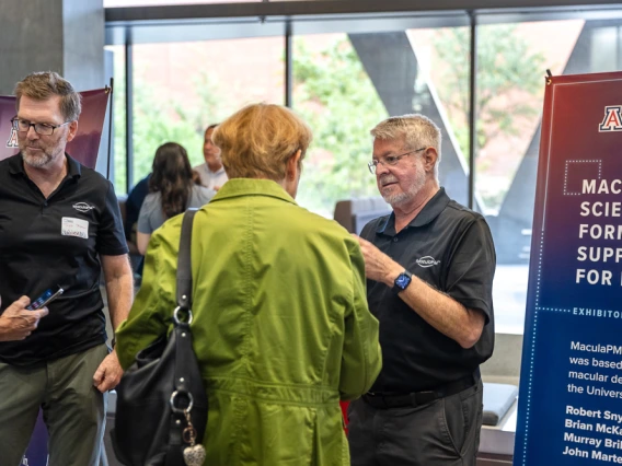 Attendees peruse expo tables at I-Squared 2025.