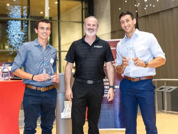 Doug Hockstad presents the Student Innovators of the Year honors to Nicolas Deshler (left) and Itay Ozer (right).