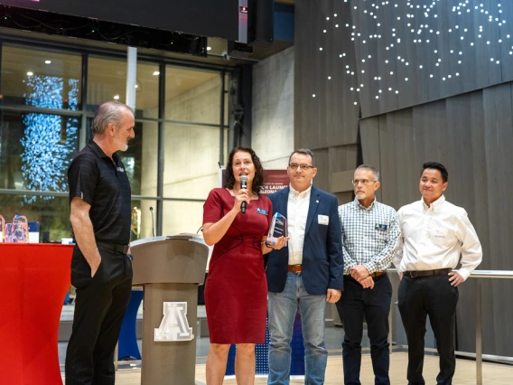 Doug Hockstad presents the Campus Collaboration award to the College of Science team: Carmie Garzione, Daniel Apai, Brad Story and Jeff Pyun.