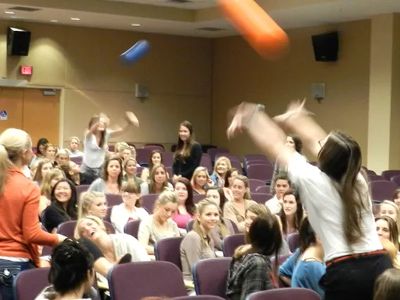 Spencer Gorin (far right) facilitates The Buzz program for an audience of students.