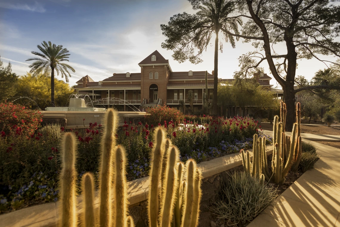 Photograph of a sunrise over the Old Main building. 