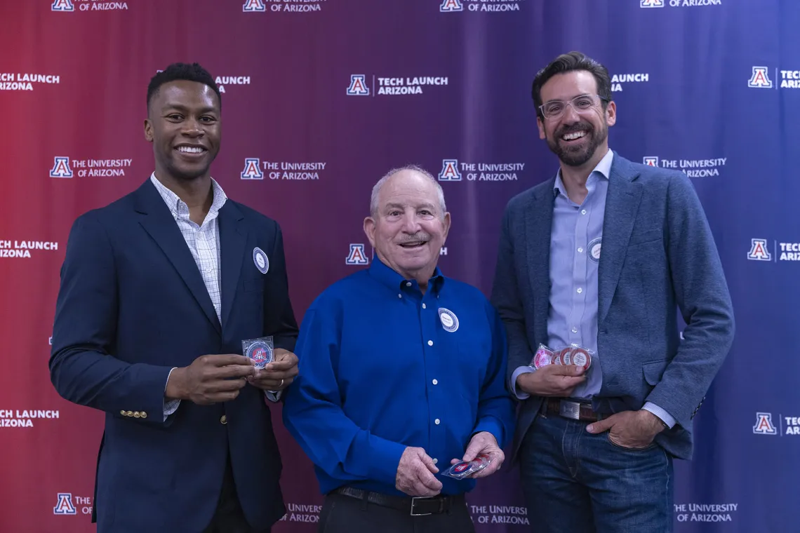 Ike Chinyere, Steven Goldman, and Jordan Lancaster with their patent coins.