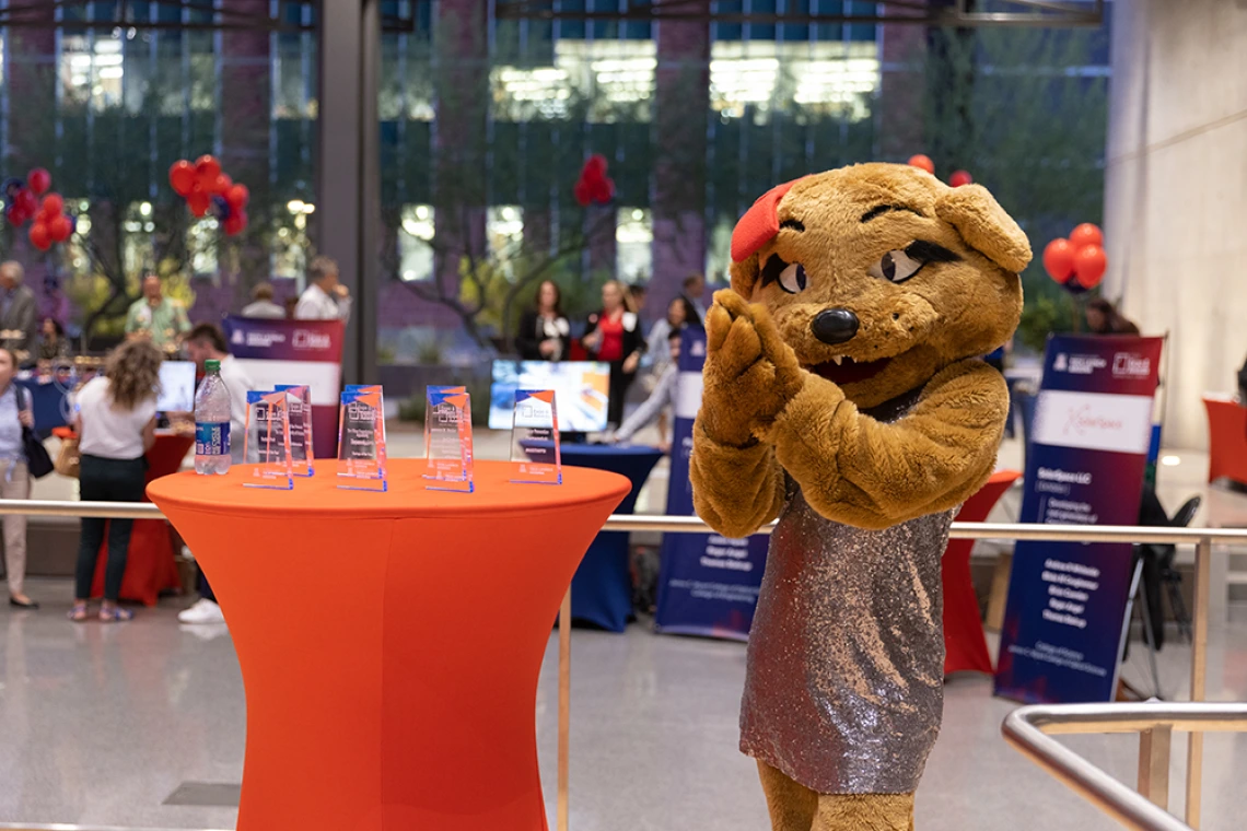 Wilma WIldcat poses with the 2022 I-Squared awards, ready to be handed out to the recipients.