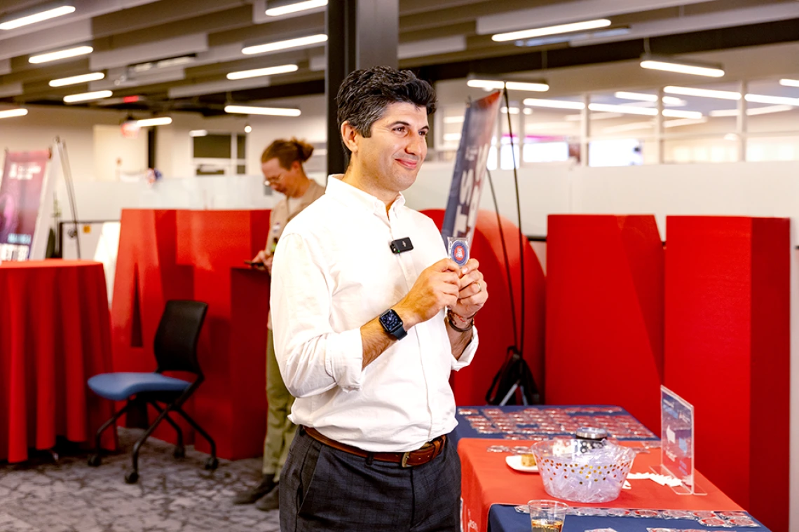 Iman Daryaei poses with his new patent coin.