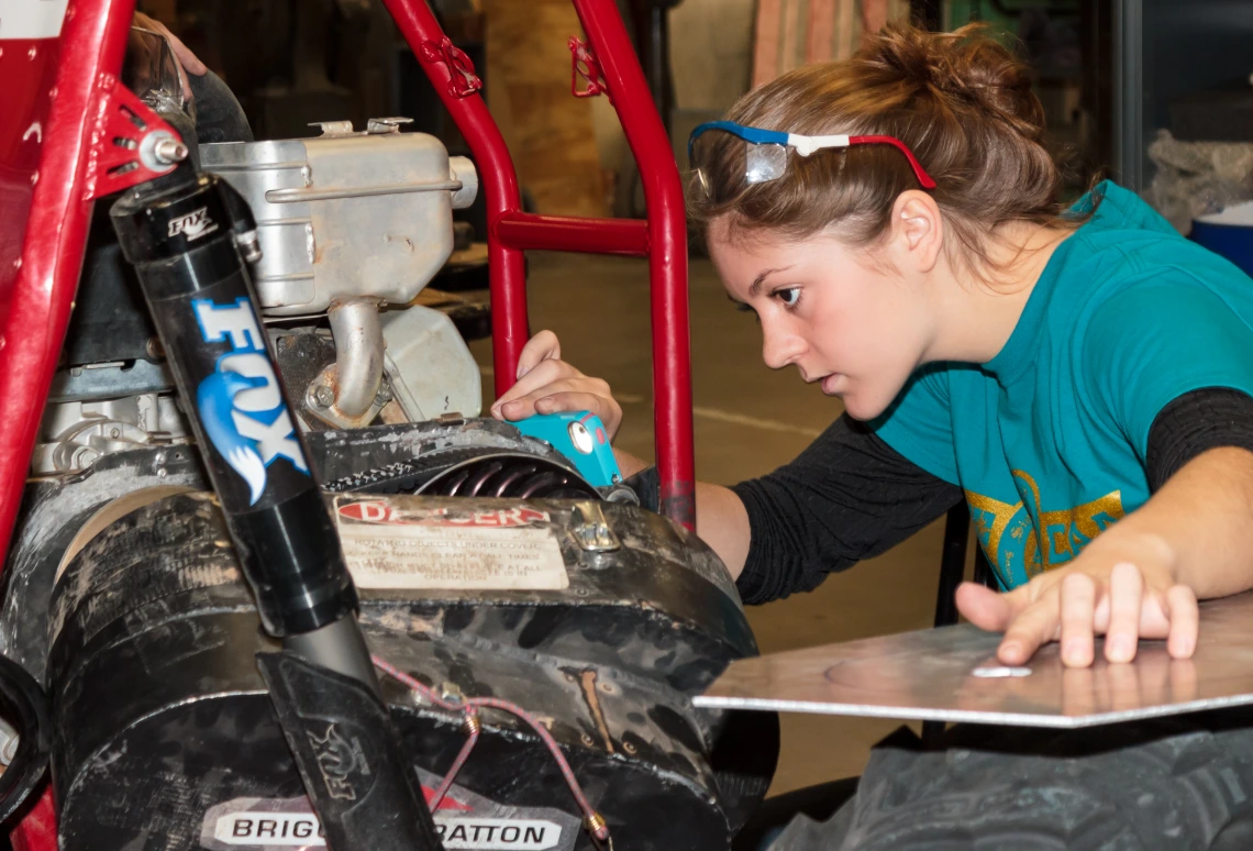 A student working on an engine.