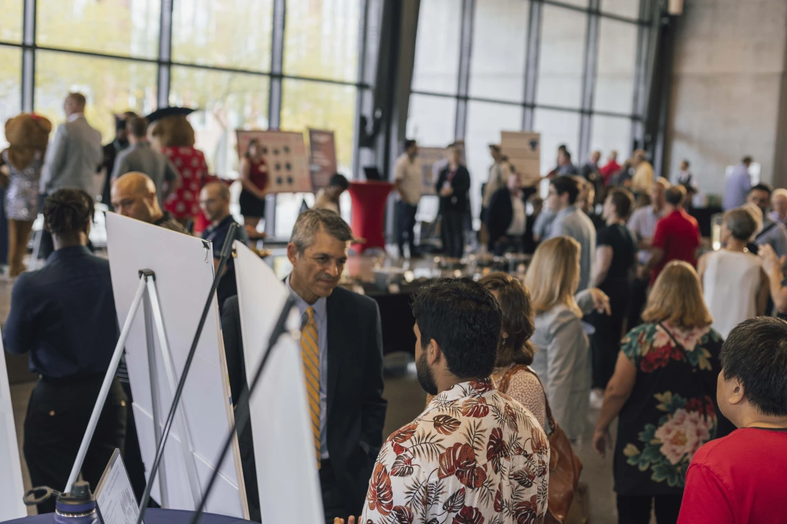 The attendee crowd of faculty, staff, students and community members peruse the technology and startup expo at I-Squared 2024. 