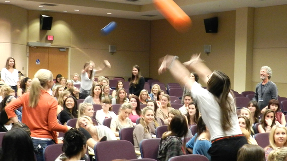 Spencer Gorin (far right) facilitates The Buzz program for an audience of students.