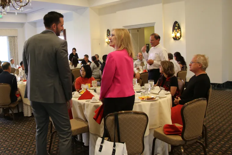 People gathering at a TLA networking event.