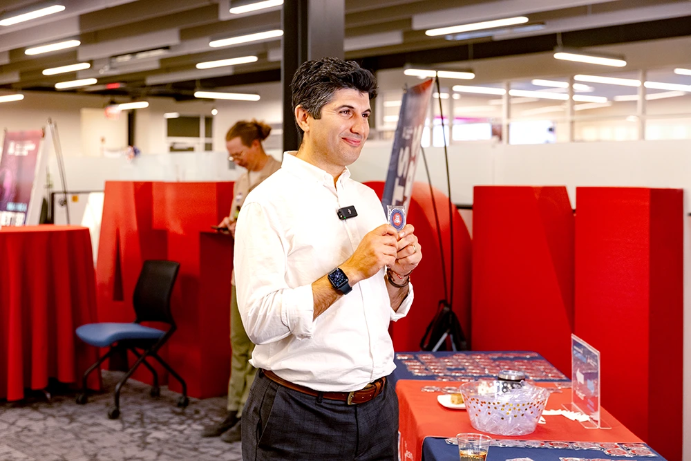 Iman Daryaei poses with his new patent coin.