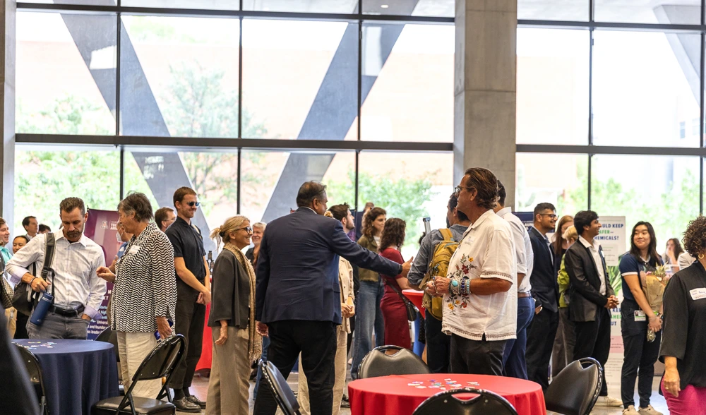Attendees peruse expo tables at I-Squared 2025.