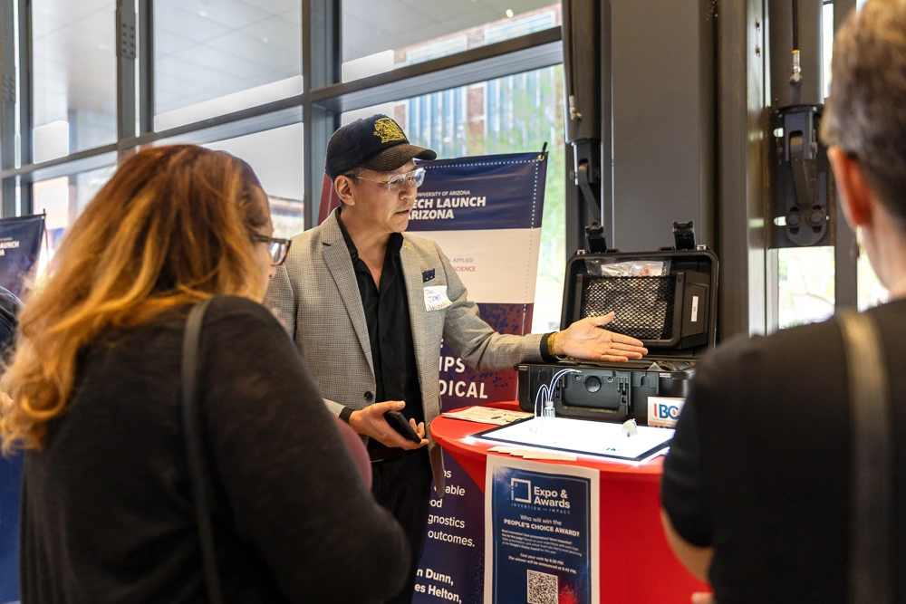 Attendees peruse expo tables at I-Squared 2025.
