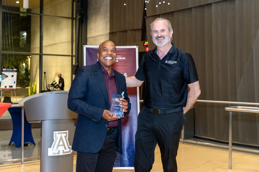 Doug Hockstad presents the Startup of the Year award to Mark Nelson of Precision Epigenomics.