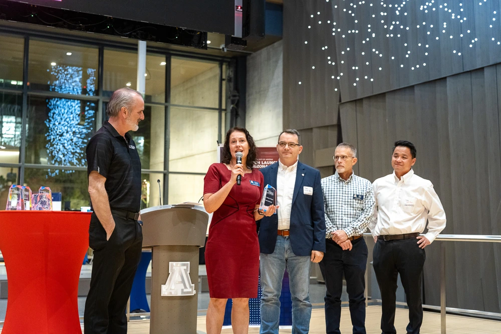 Doug Hockstad presents the Campus Collaboration award to the College of Science team: Carmie Garzione, Daniel Apai, Brad Story and Jeff Pyun.