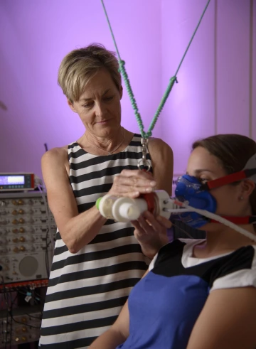 Fiona Bailey performing a breathing test on a subject in the lab.