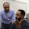 Abhijit Mahalanobis (standing on the left), in discussion with doctoral student Natnael Daba, sitting to his right.