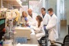 In a photo taken prior to the pandemic, Dr. Chilton (second from left) and his lab team examine how genetic and epigenetic variations interact with human diets to drive inflammation and inflammatory disorders, as well as psychiatric and developmental disorders.