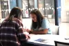 Two students sitting at a table in the Catalyst Center. 